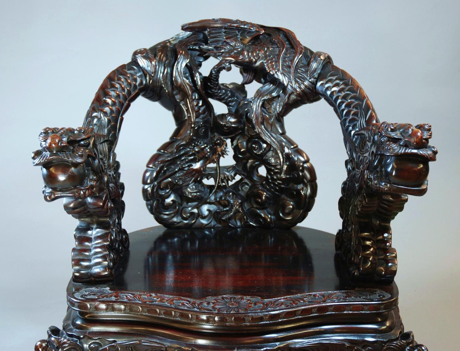 Pair of heavily carved Chinese dragon chairs