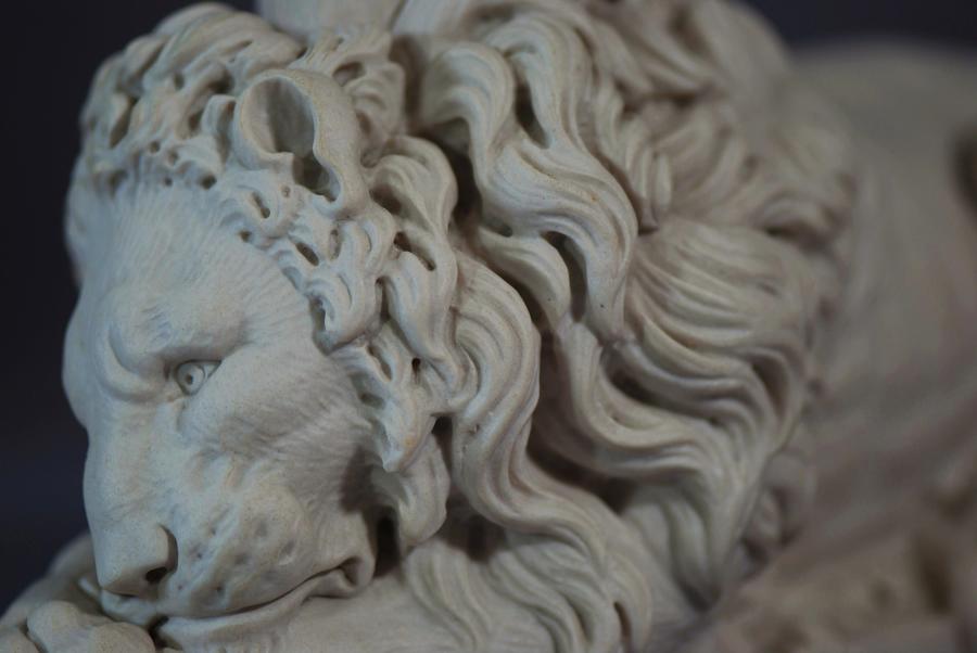 Pair of composition 20thc lions 