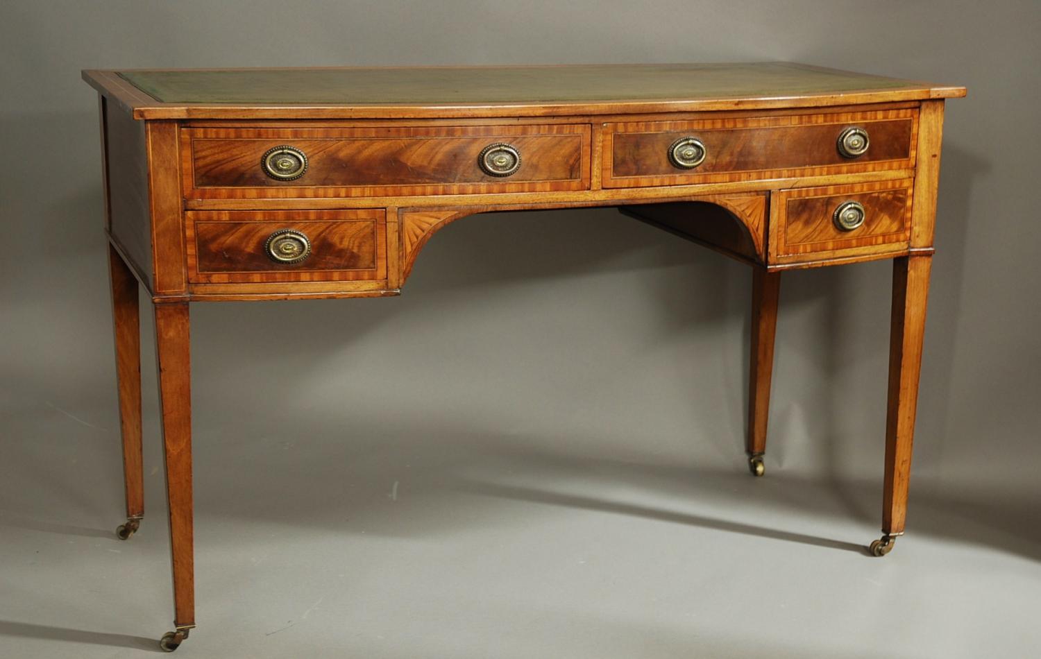 Shoolbred mahogany bow-fronted writing table
