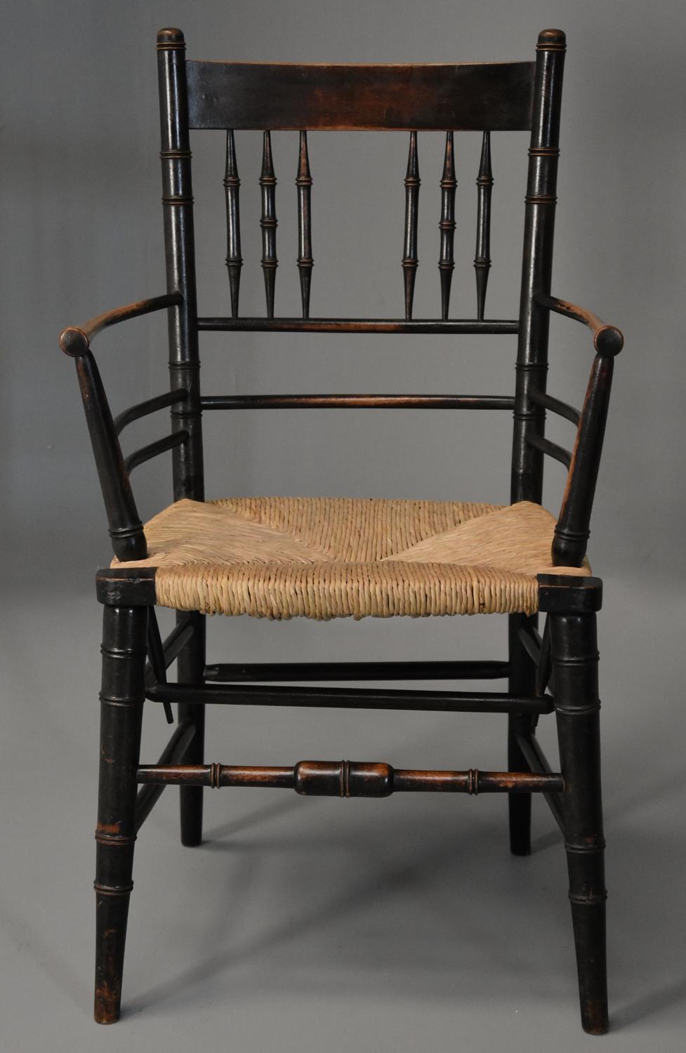 Late 19th century ebonised Sussex armchair attributed to Morris & Co.