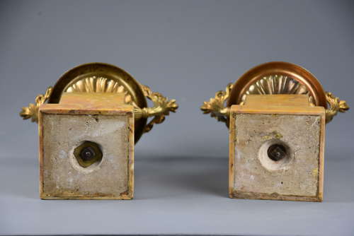 A pair of gilt metal tazzas on marble bases in the Neoclassical style