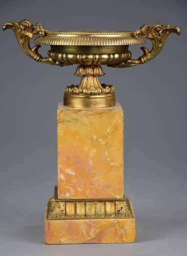 A pair of gilt metal tazzas on marble bases in the Neoclassical style