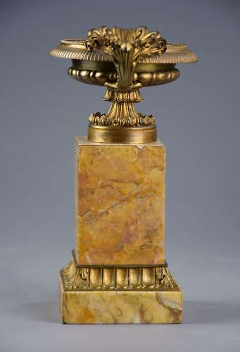 A pair of gilt metal tazzas on marble bases in the Neoclassical style