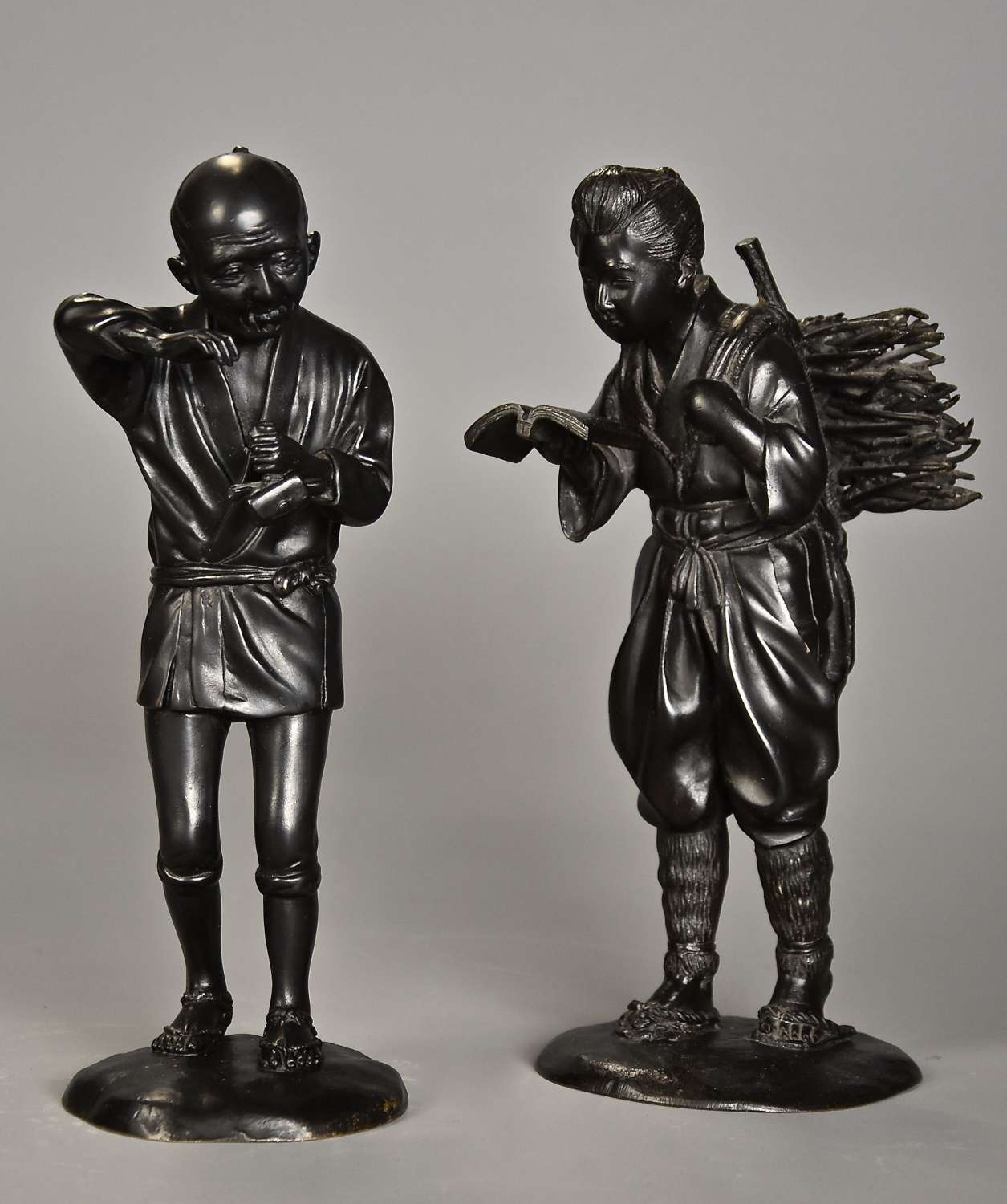 Pair of fine quality Meiji Japanese bronzes of a peasant man & woman