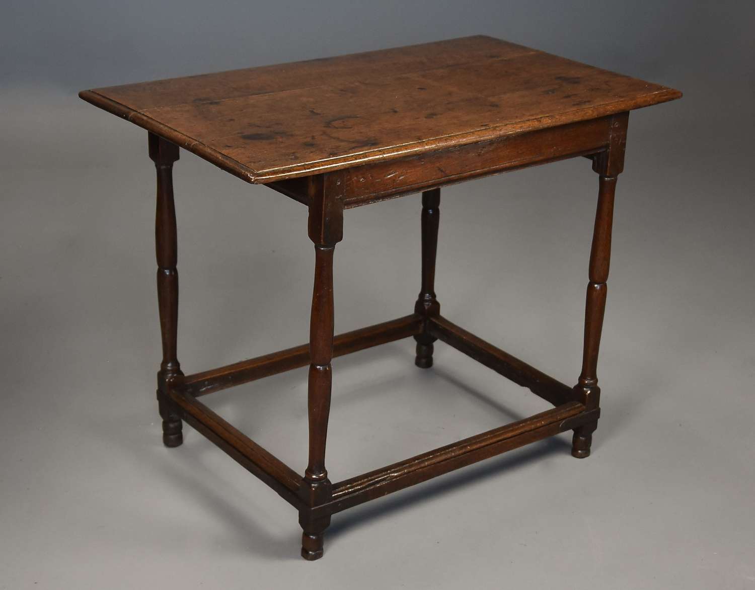 An unusual early 18th century oak tavern table of fine patina
