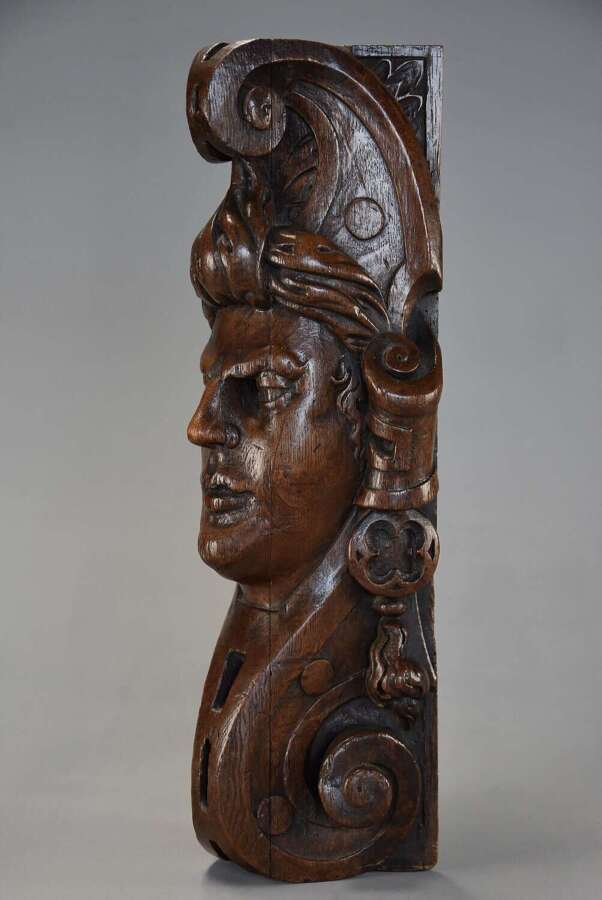 Late 17th century carved oak corbel in the style of a Medieval man, possibly Continental