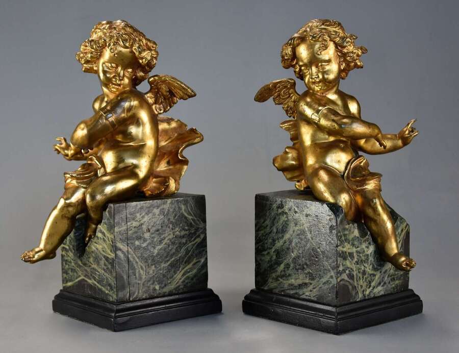 Pair of fine quality early 19thc French ormolu winged cherubs seated on faux marble bases